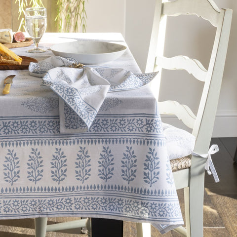 Blue and white tablecloth and napkins with white painted chair