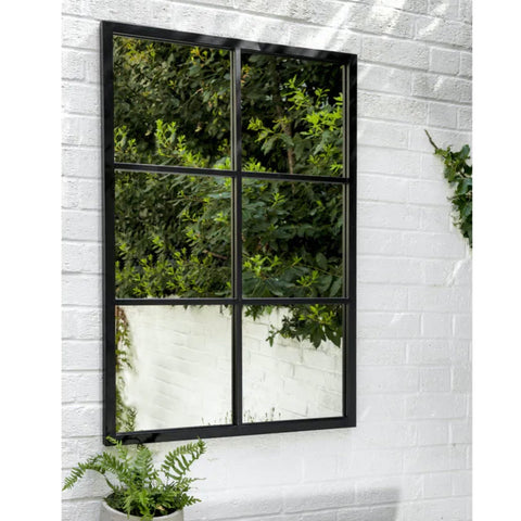 Window mirror with black metal frame on white wall
