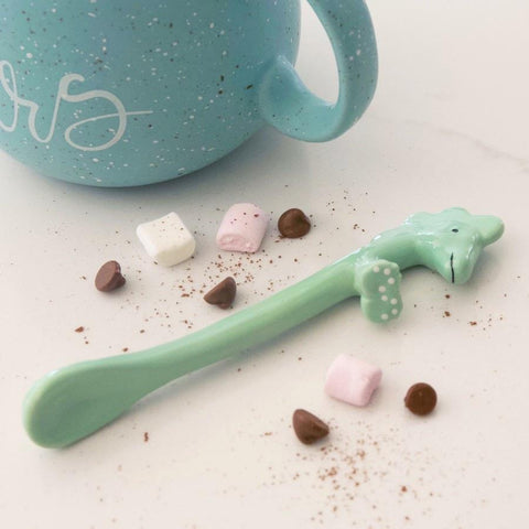 Dinosaur shaped spoon with hot chocolate mug and marshmallows