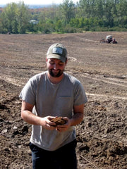 One of the owners of Rove Estate Winery, Creighton Gallagher, holding soil.