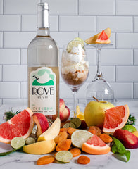 A bottle of Rove Estate's Pinot Grigio surrounded by an assortment of fruit.