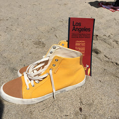 image of yellow sneakers and a map of Los Angeles on a beach