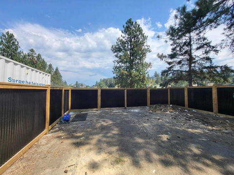 Corrugated Metal Fencing Panels In A Backyard