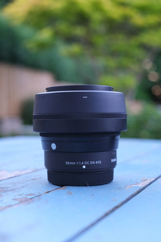 SigSigma 56mm f1.4 for Fujifilm X-Mount on a blue table