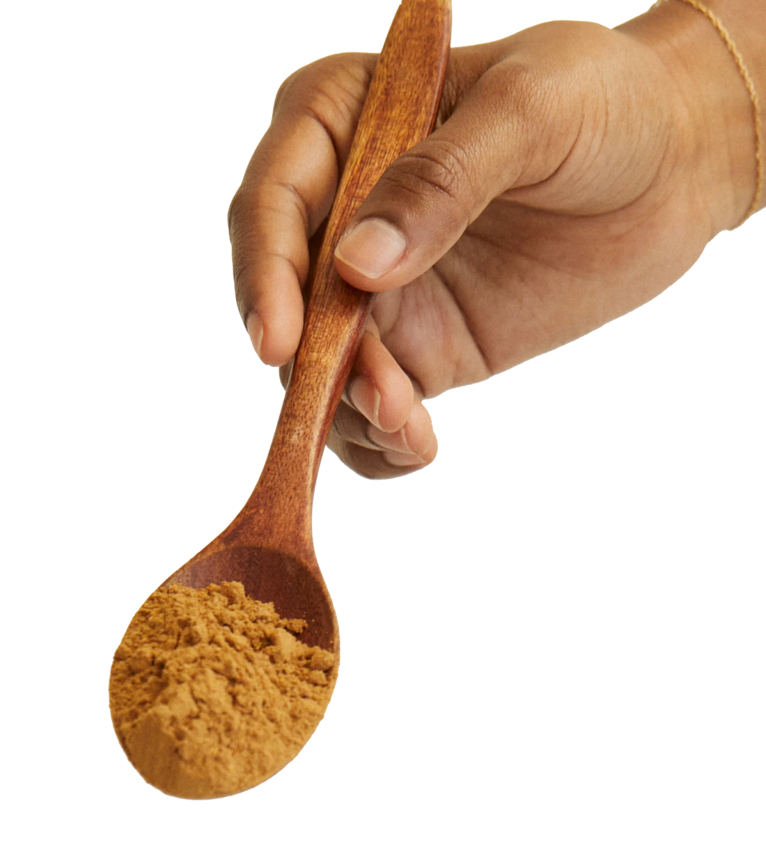 A hand holding a spoon with a natural plant extract