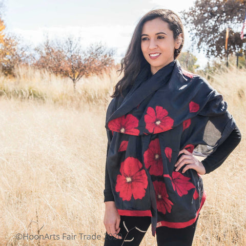 Handmade felted silk scarf from Kyrgyzstan, large red felted poppies on black silk, on young Latinx female model 