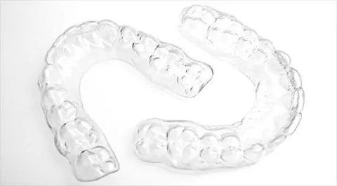 Clear Essix retainer, similar to an Invisalign aligner, shown on a white background.