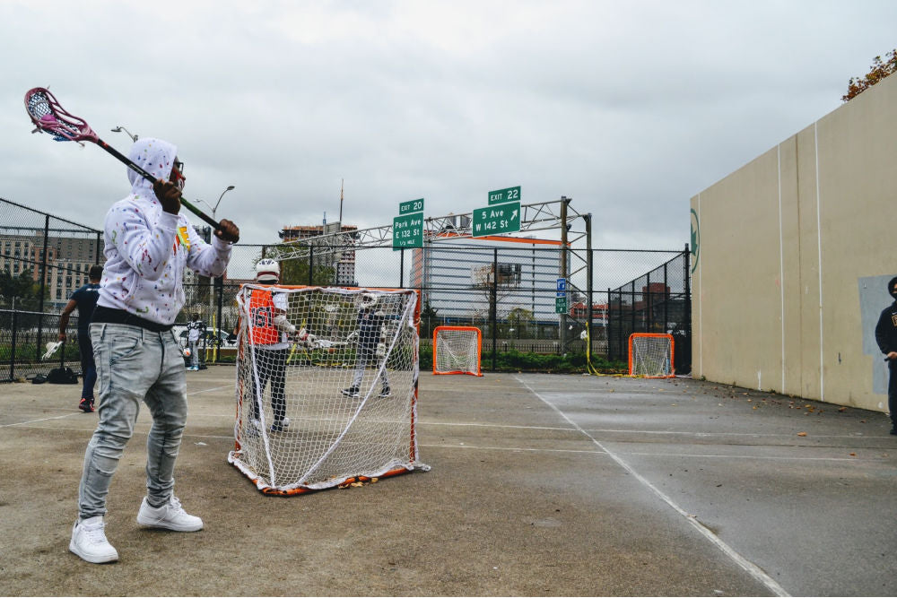 Harlem Lacrosse players on concrete