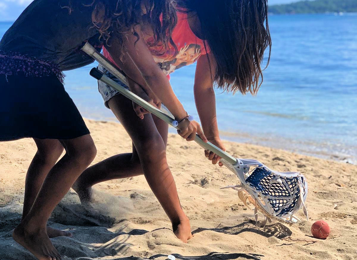 Lacrosse the Nations girls playing lacrosse on the beach