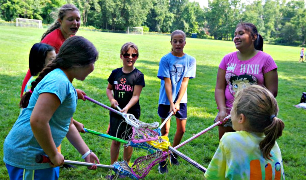 Girls showing confidence learning lacrosse