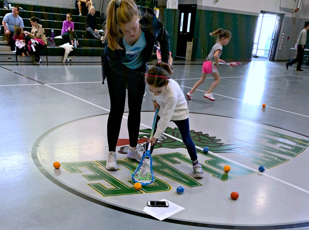 Coach Eve breaks down how to properly pick up ground balls during Swax Lax Lacrosse indoor clinic