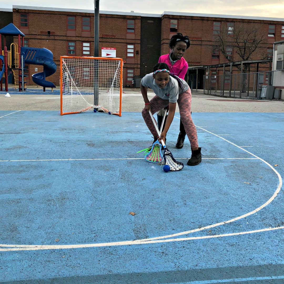 Harlem Lacrosse playing outdoors using a Swax Lax soft lacrosse training ball