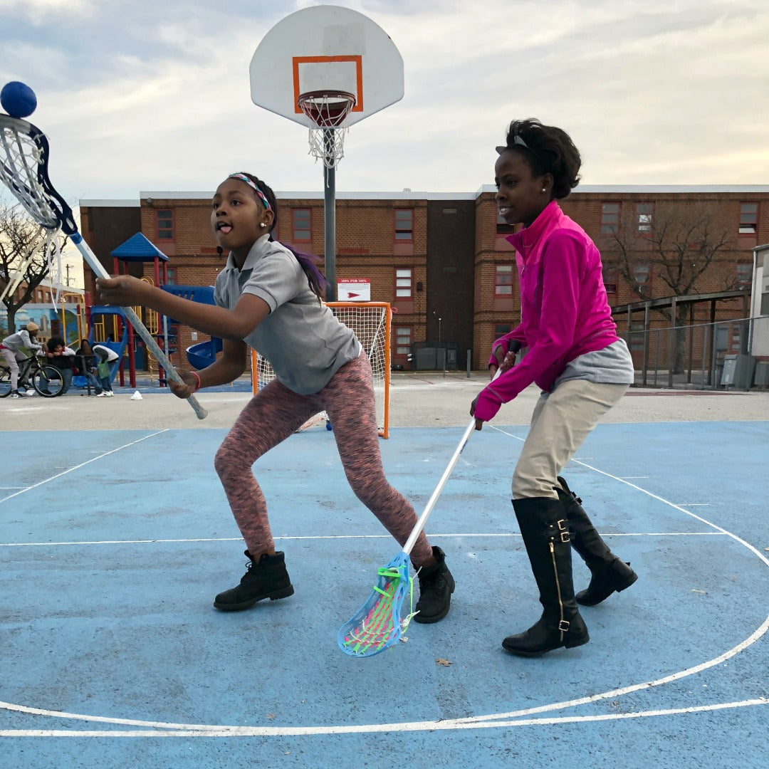 Harlem Lacrosse girls having fun practicing lacrosse outdoors using Swax Lax soft lacrosse training balls