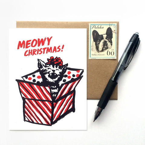 'Meowy Christmas' card, with a stamped envelope and pen in the background