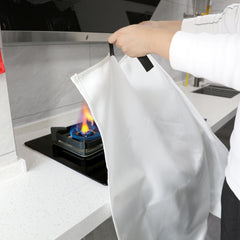 CAREFULLY COVER THE OPEN FLAME Drape the Fire Blanket over the flames to seal off the air.