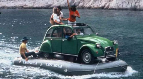 Auf einem Zodiac Boot von Marina Wassersport steht ein Citroen 2CV