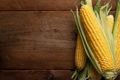 Corn on wooden background