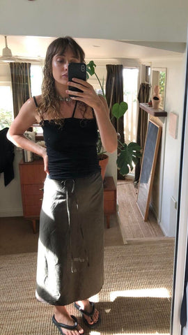 Emma’s summer go-to, Apron Dress in Pine worn as a wrap skirt