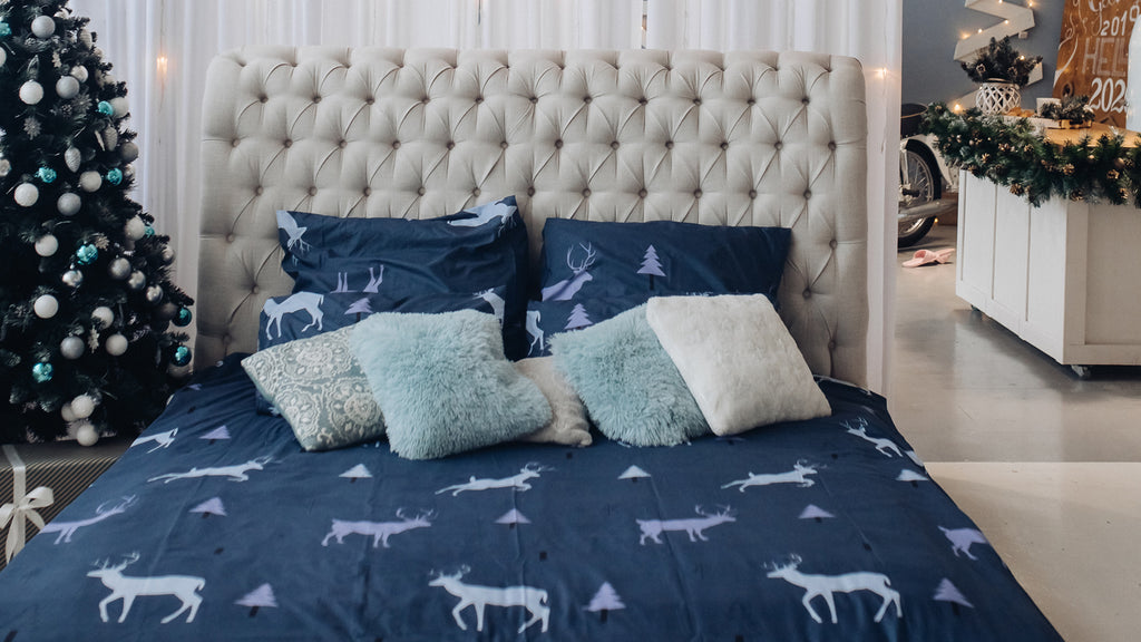 blue and grey cushions on bed