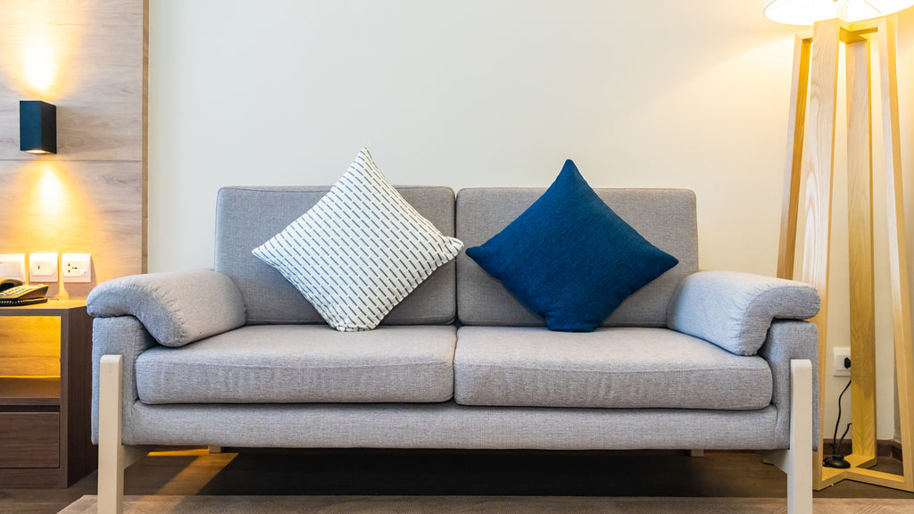 light grey sofa with blue cushion