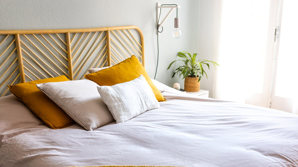 bed with yellow cushions and white cushions