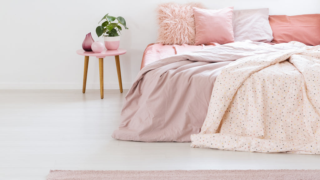 pink cushion covers on bed