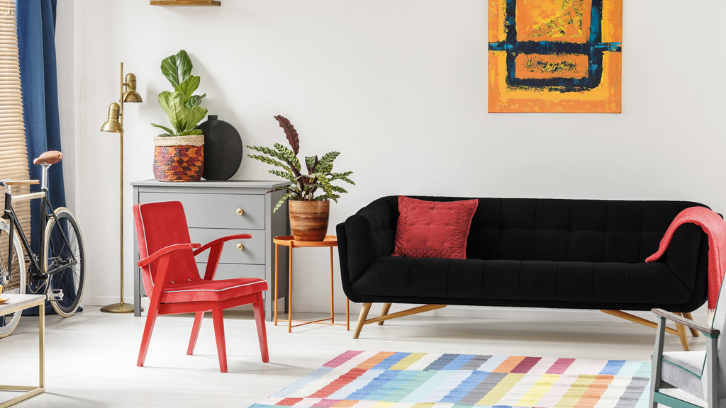 black sofa with red cushion covers