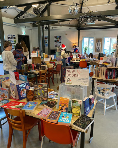 A large room with tables piled high with books