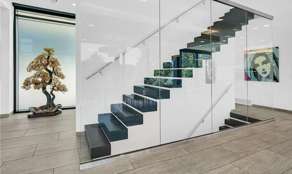 Image of a hallway, showing the stairs up and down floors, as well as the Citrine Tree on the left in a nook