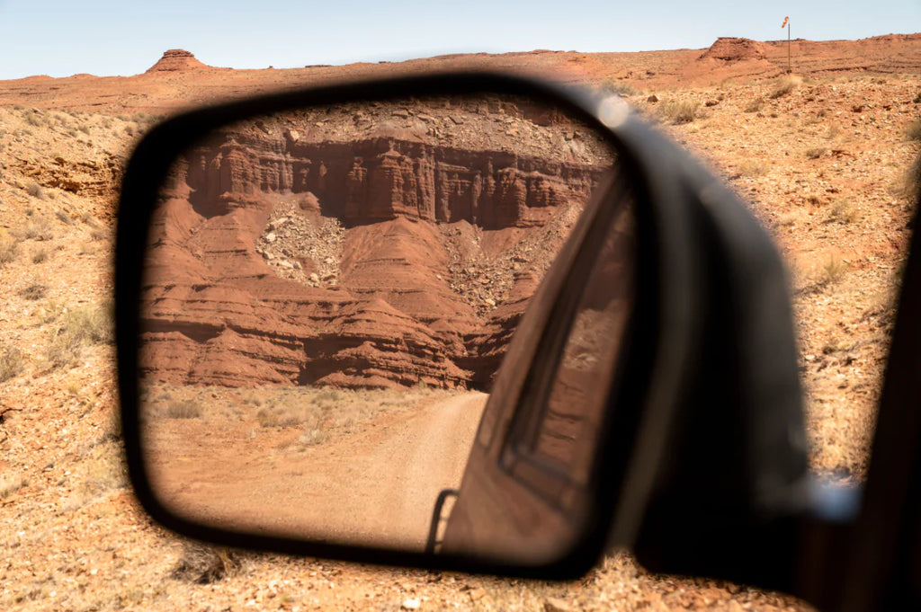 rearview mirror in desert scene