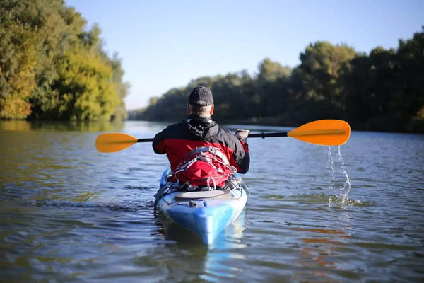 man kayaking down river