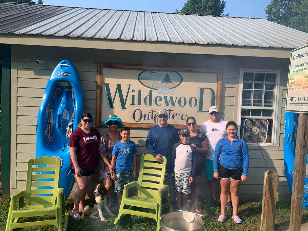 Family standing in front of Wildwood Outfitters
