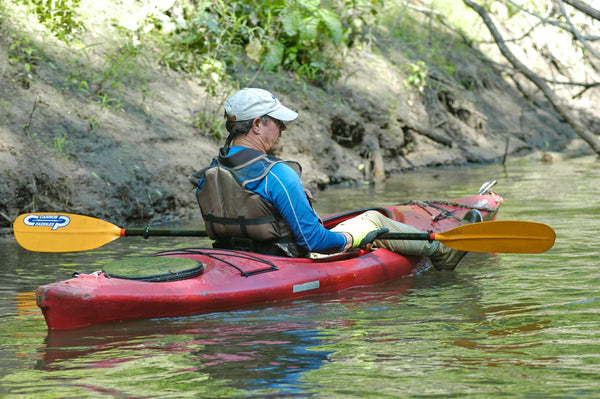 Man resting in his red kayak