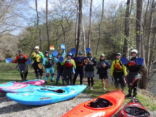 Group of paddlers learning how to whitewater kayak