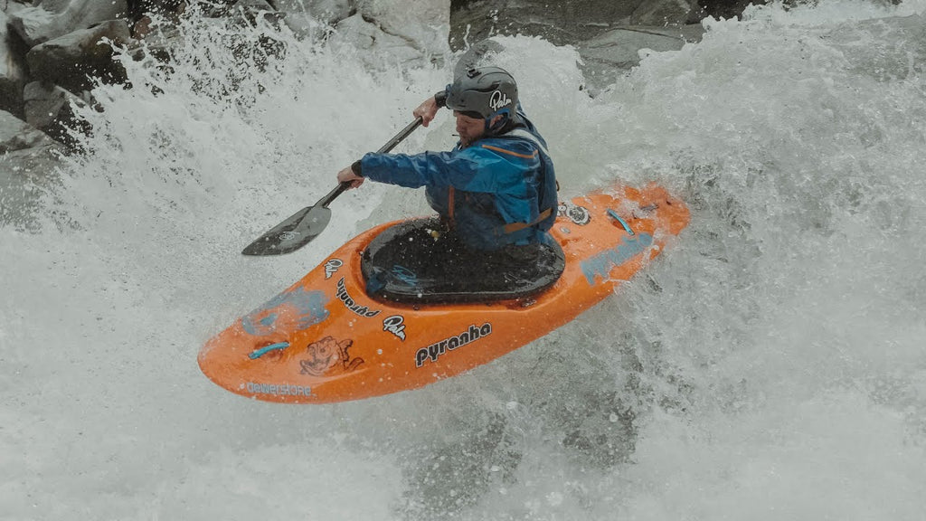 Kayaker doing advanced tricks on rapid