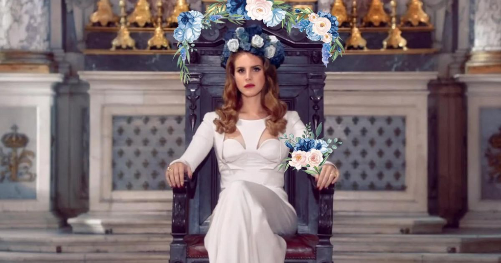 Lana Del Rey sitting in a flower-filled throne holding a flower bouquet.