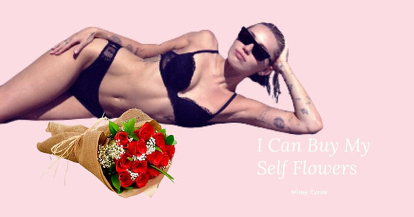 Photo of Miley Cyrus with roses celebrating her song “Flowers”.