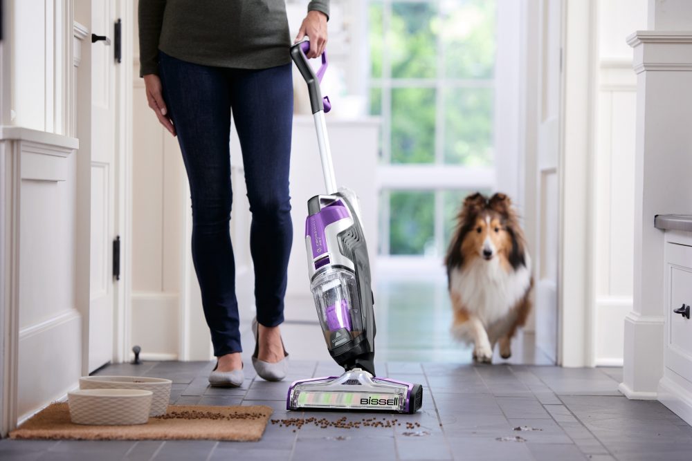bissell crosswave pet multi surface cleaner on a hardwood floor with a dog