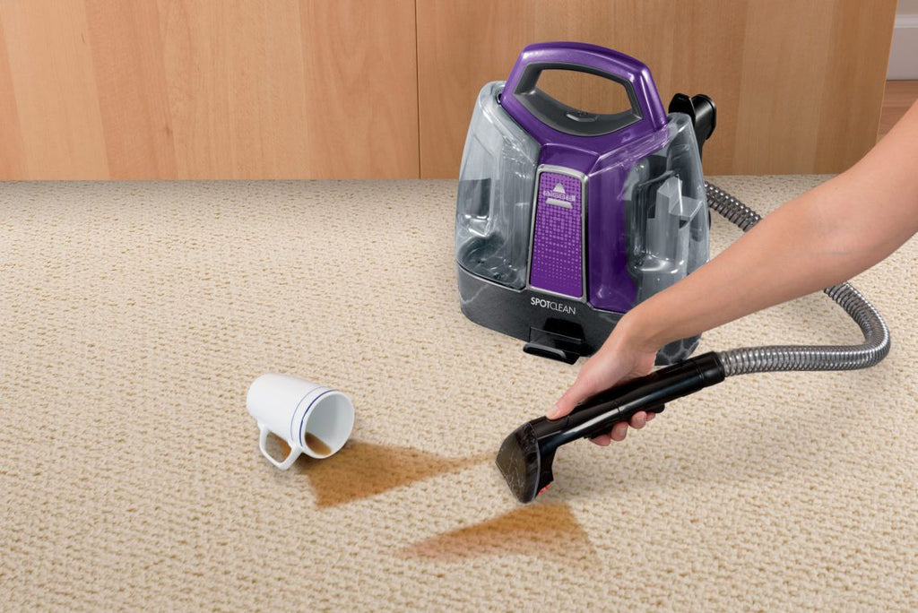 bissell spotclean carpet and upholstery cleaner cleaning up coffee spilled onto beige carpet
