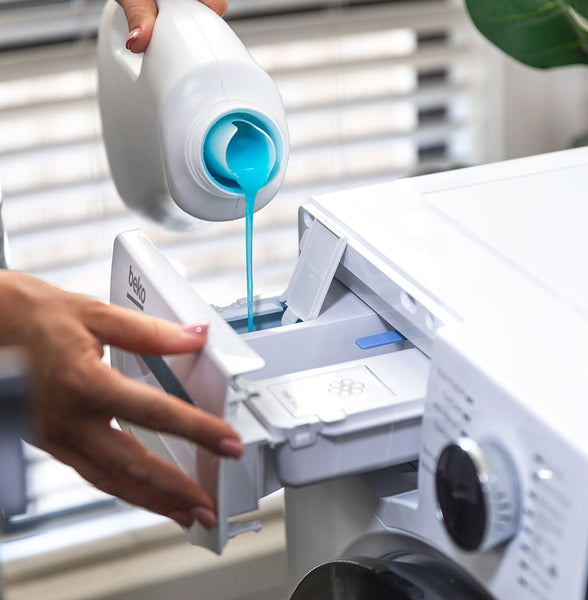 laundry detergent being poured into a Beko AutoDose washing machine