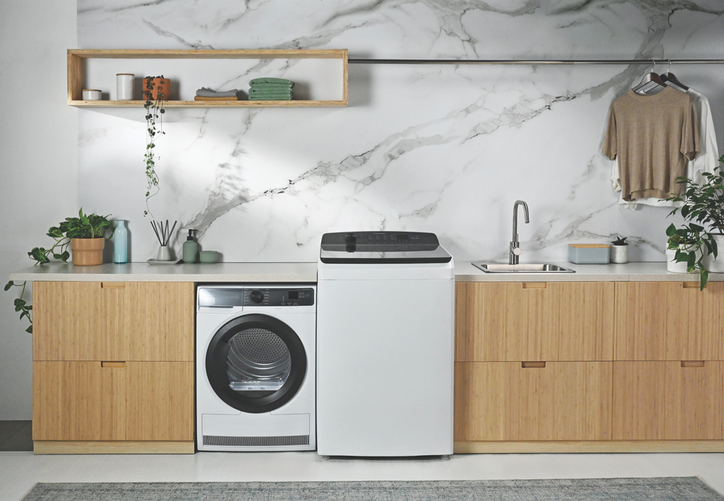 Westinghouse 8kg Heat Pump Dryer in a laundry with light oak cabinets and a Westinghouse top load washing machine