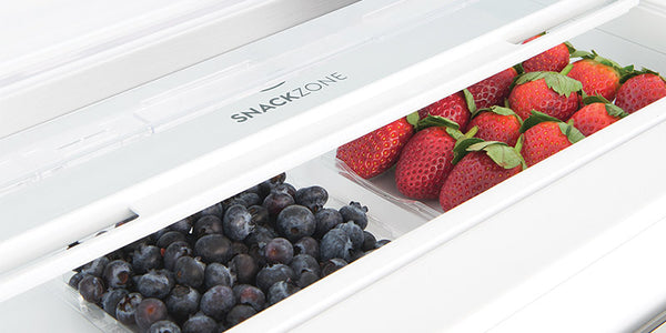 image showing the snackzone compartment of a french door fridge, with blueberries on the left and strawberries on the right
