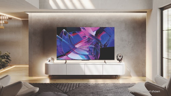 A Hisense 75u7kau tv on a wall in a minimalist beige decor living room with a charcoal rug