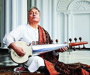Indian Classical Musician Ustad Amjad Ali Khan playing the rabab instrument
