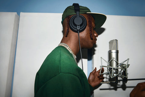 Rapper wearing studio headphones while recording vocals