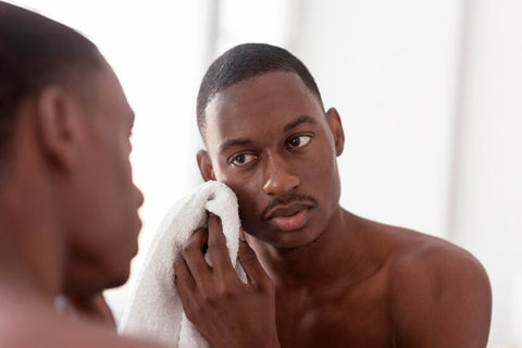 Melanin Skincare - close-up-man-cleaning-his-face