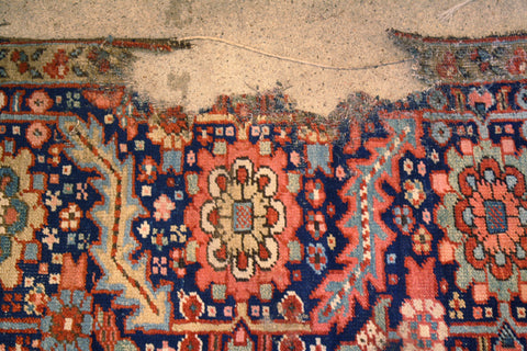 Damaged Persian Heriz rug