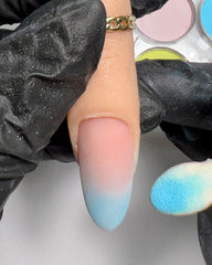 practice finer with matte peach nail tip with soft blue ombre and sponge applicator.