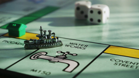 Monopoly game board with pieces on the board