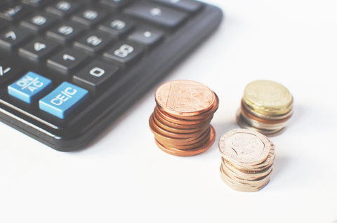 piles of change and a calculator